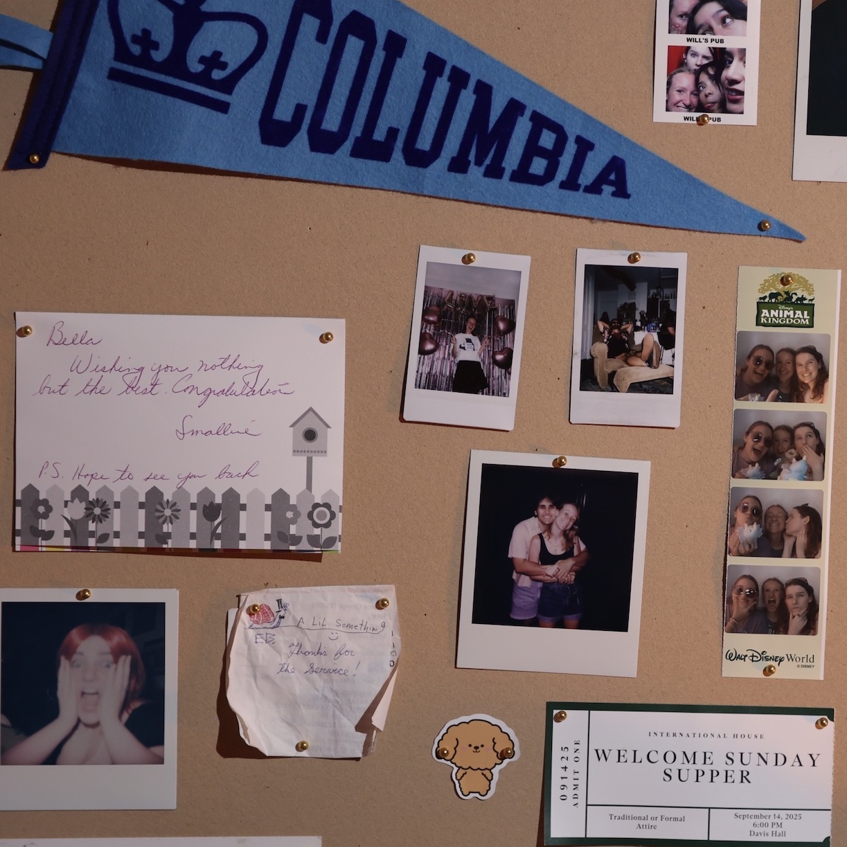 Photo of a bulletin board with photos of friends, a Columbia University flag, and handwritten letters pinned to it.